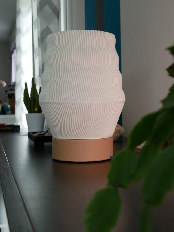 White lamp design and printed by homa kraft. The lamp is inside, turn off and use a lamp-base design by us. It's on a furniture