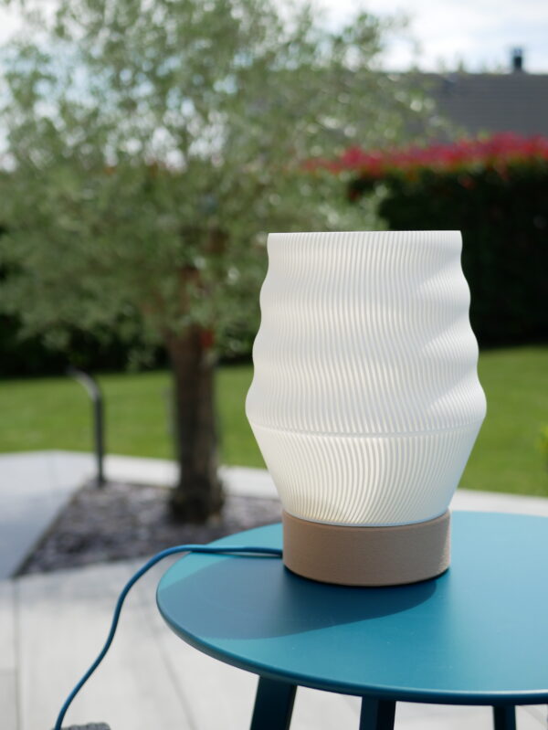 White lamp design and printed by homa kraft. The lamp is outside, turn on and use a lamp-base design by us.